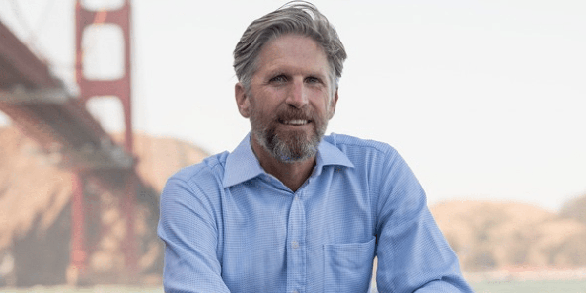 A determined entrepreneur, perhaps a person of middle age, looking confidently towards a bright future, symbolizing innovation and resilience in the tech industry.