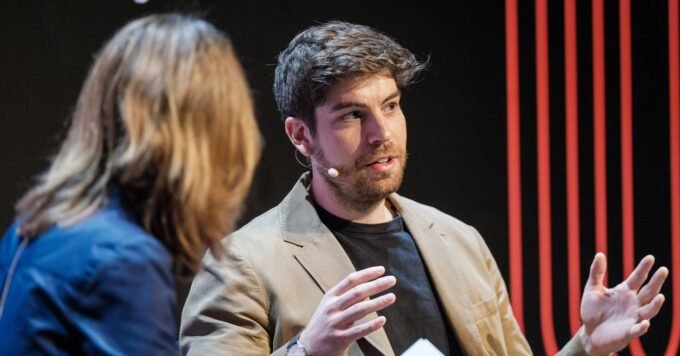 An abstract image showing interconnected molecular structures and glowing AI neural network elements, symbolizing AI-driven drug discovery entering human trials.