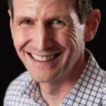 A person looking at a digital screen with AI-related graphics, symbolizing the impact of artificial intelligence on the workforce.