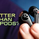 Various wireless earbuds, including AirPods Pro and several alternatives, laid out on a clean surface.