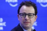 A stylized graphic representing AI technology, possibly with network lines and a subtle government or security agency emblem in the background.