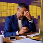 A founder performing bilateral stimulation, tapping their chest, with a calm expression, symbolizing stress resolution.