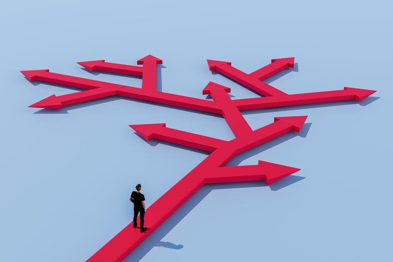 Bitcoin logo against a backdrop of stock market charts, symbolizing its underperformance against equities.