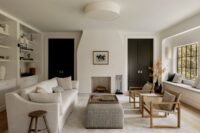 Exterior view of the renovated Croton-on-Hudson stone residence by Ravi Raj, showcasing the blend of original masonry and modern lap siding.