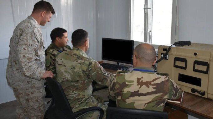 صورة توضيحية لجنود مغاربة وأمريكيين يتبادلون المعلومات عبر أنظمة اتصالات عسكرية متطورة.