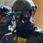 وكالة الهجرة الأمريكية توضح: لا أسلحة لعملاء ICE في كندا قبيل كأس العالم 2026 6 عميل حرس حدود أمريكي يقف حارسًا خارج منشأة وكالة الهجرة والجمارك الأمريكية في بورتلاند، أوريغون.