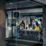 Beyond the Scorecard: Why Direct Observation is Your Most Powerful Leadership Tool 6 A leader observing their team's work intently, perhaps with a football field in the background, symbolizing direct engagement.