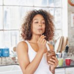 Woman enjoying an early morning meal, symbolizing optimized metabolic health through time-restricted eating.