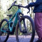 The Electrifying Dilemma: Why Fixing Your E-Bike Is Harder Than Ever 3 A skilled mechanic carefully inspecting the motor of an electric bicycle on a repair stand.