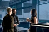 A diverse group of professionals collaborating with kindness and empathy in a modern office setting, symbolizing positive business relationships.