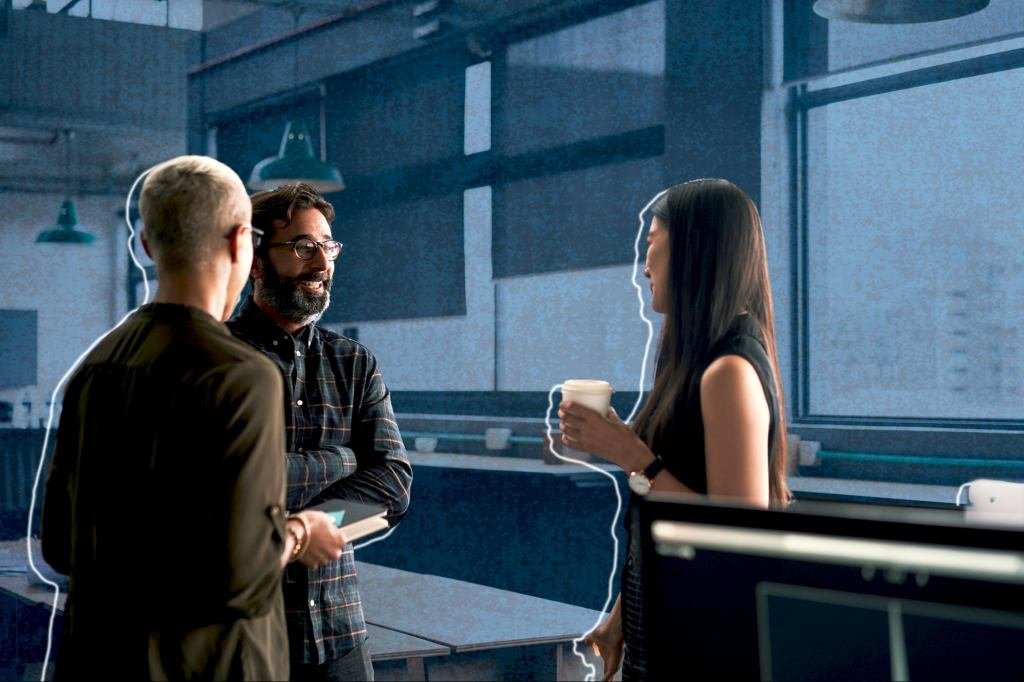 A diverse group of professionals collaborating with kindness and empathy in a modern office setting, symbolizing positive business relationships.