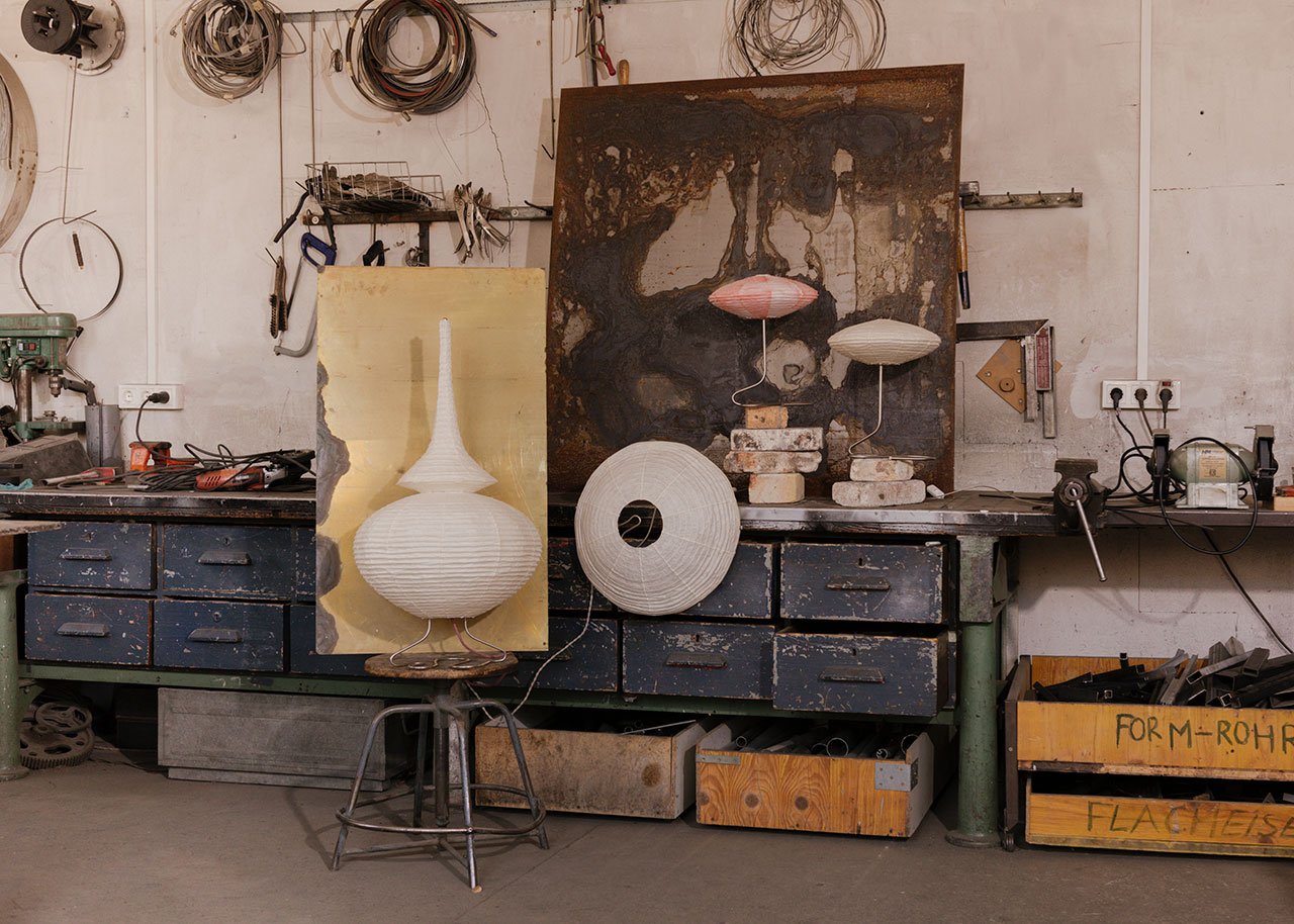 A collection of sculptural lamps from Endless Flat Studio, featuring delicate Japanese Kozo paper shades on hand-bent stainless steel bases, inspired by serpentine forms and ancient narratives.