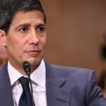 A visual representation of economic indicators, including rising inflation and interest rate charts, with the Federal Reserve building in the background.