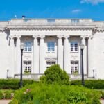 An opulent grand staircase inside a governor's mansion, showcasing intricate architectural details.
