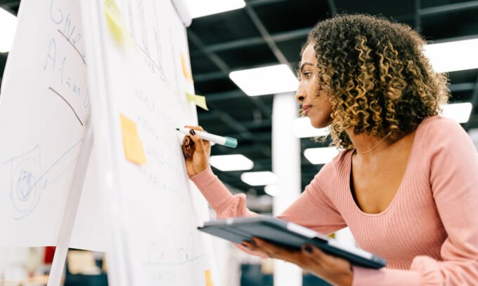 An introvert contemplating career choices with a pen and notebook