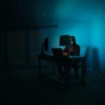 Illustration of a broken blockchain bridge with digital currency flowing out, representing the Kelp DAO exploit.