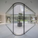 Defying Constraints: KWK Promes' Trim House Reimagines Modern Living 6 The Trim House by KWK Promes, featuring sharp concrete and glass angles around an interior courtyard in Vilnius, Lithuania.