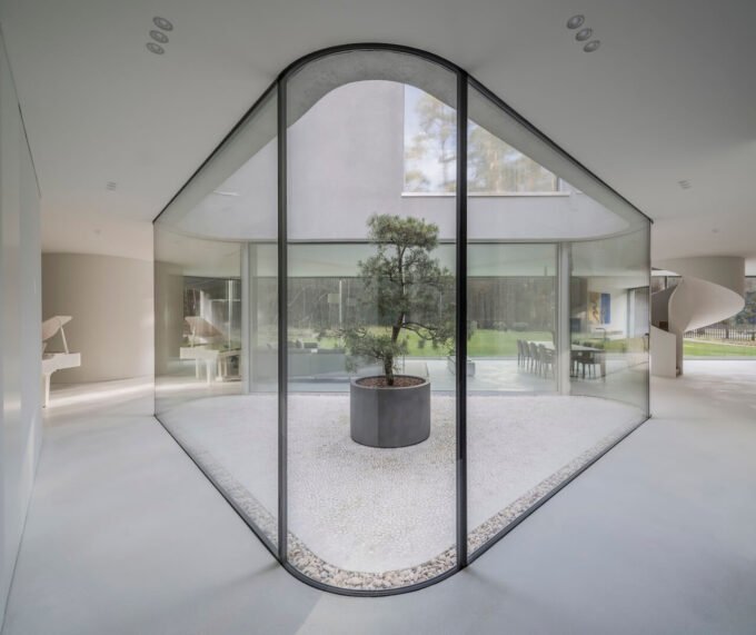 Defying Constraints: KWK Promes' Trim House Reimagines Modern Living 7 The Trim House by KWK Promes, featuring sharp concrete and glass angles around an interior courtyard in Vilnius, Lithuania.