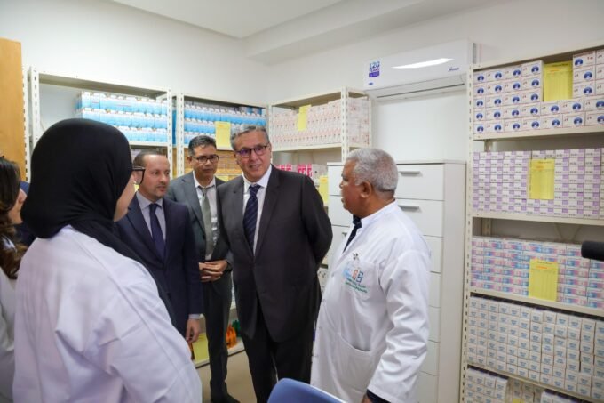 Moroccan officials, including Akhannouch and Tahraoui, inspecting a newly upgraded primary health center with modern equipment.