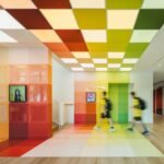 Vibrant music classroom at Wester Academy Beijing designed by studio vapore, featuring colorful acoustic panels and modern furnishings.