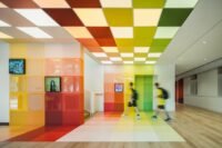 Vibrant music classroom at Wester Academy Beijing designed by studio vapore, featuring colorful acoustic panels and modern furnishings.