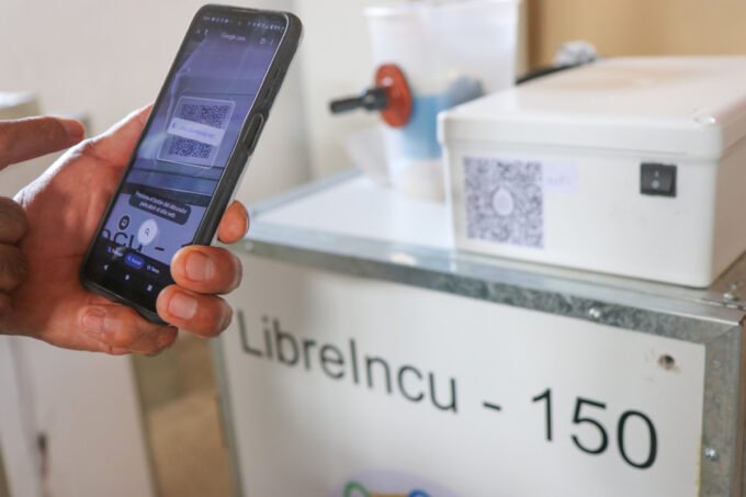 A collage or graphic representing diverse open source hardware projects, including an incubator, a circuit board badge, and a synthesizer development board, all bearing the OSHWA certification logo.