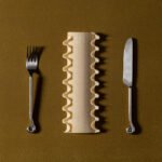 Close-up of Al Dente Collection hardware, showing pasta-inspired knobs and pulls in various metallic finishes.