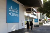 A modern financial building with 'Schwab' branding, symbolizing Charles Schwab's strategic entry into digital asset trading.