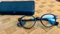 A pair of sleek smart glasses displaying a digital interface, symbolizing the choice between open and closed platforms.