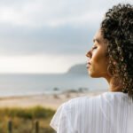 Person meditating or in a peaceful state, symbolizing surrender and spiritual connection, perhaps with light emanating around them.