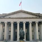 A visual representation of regulatory documents or a gavel over stablecoin symbols, illustrating the banking industry's request to pause GENIUS Act implementation.