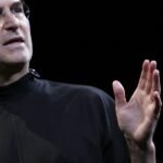 Steve Jobs speaking at a commencement ceremony, inspiring students with career advice on finding what they love.