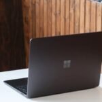 A sleek Microsoft Surface Laptop 7 with a vibrant OLED display showcasing Windows 11.