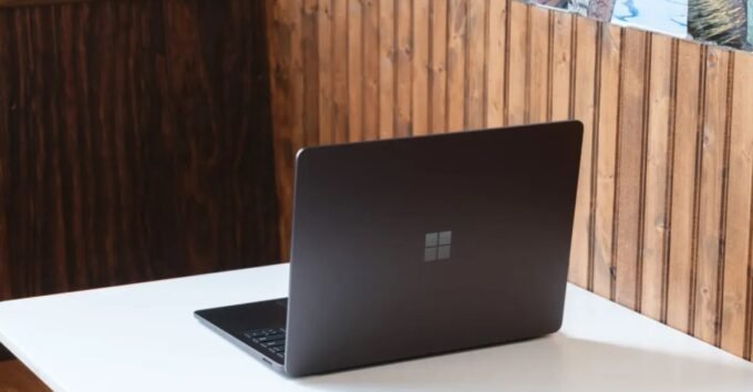 A sleek Microsoft Surface Laptop 7 with a vibrant OLED display showcasing Windows 11.
