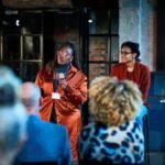 A dynamic image of a thought leader speaking confidently to an engaged audience, symbolizing influence and impact.