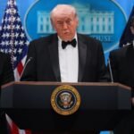U.S. President Donald Trump being escorted from the stage by Secret Service agents during a shooting incident at the White House Correspondents' Dinner.