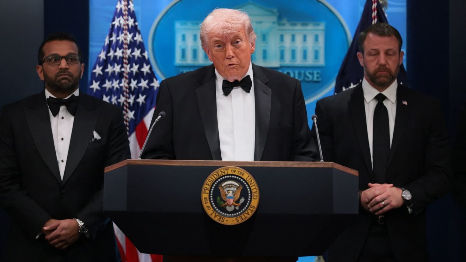 U.S. President Donald Trump being escorted from the stage by Secret Service agents during a shooting incident at the White House Correspondents' Dinner.