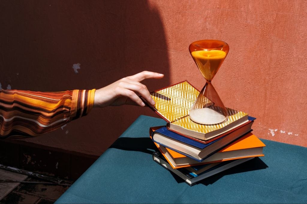 A stack of diverse business books on a desk, symbolizing knowledge and resilience in the modern workplace.