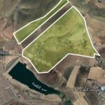 Vue aérienne de la zone industrielle Ain Bida à Fès, avec des usines et des espaces verts, symbolisant le repositionnement vers un développement durable.