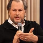 Salesforce CEO Marc Benioff discussing AI's impact on the tech job market with a graph showing sales growth.