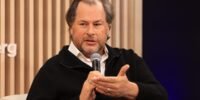 Salesforce CEO Marc Benioff discussing AI's impact on the tech job market with a graph showing sales growth.