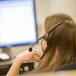 A person using a voice dictation app on a computer in a modern office setting