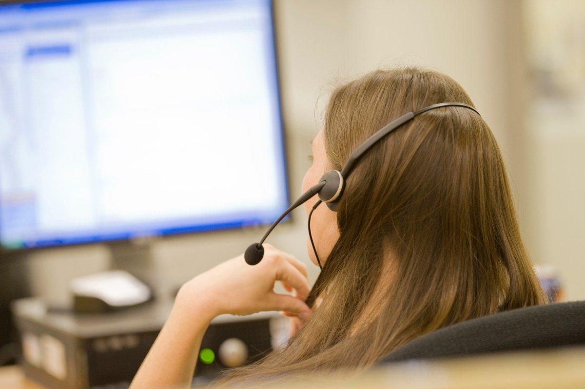 A person using a voice dictation app on a computer in a modern office setting