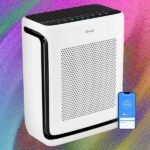 A sleek, modern air purifier silently operating in a brightly lit living room, symbolizing clean and fresh indoor air.