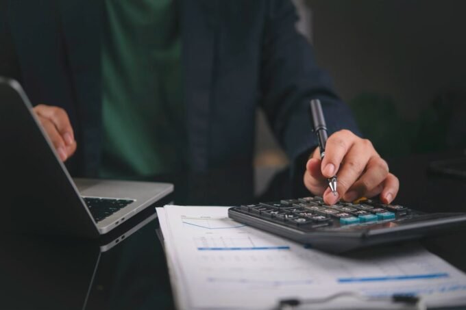 E-commerce founder reviewing tax documents and financial statements on a laptop