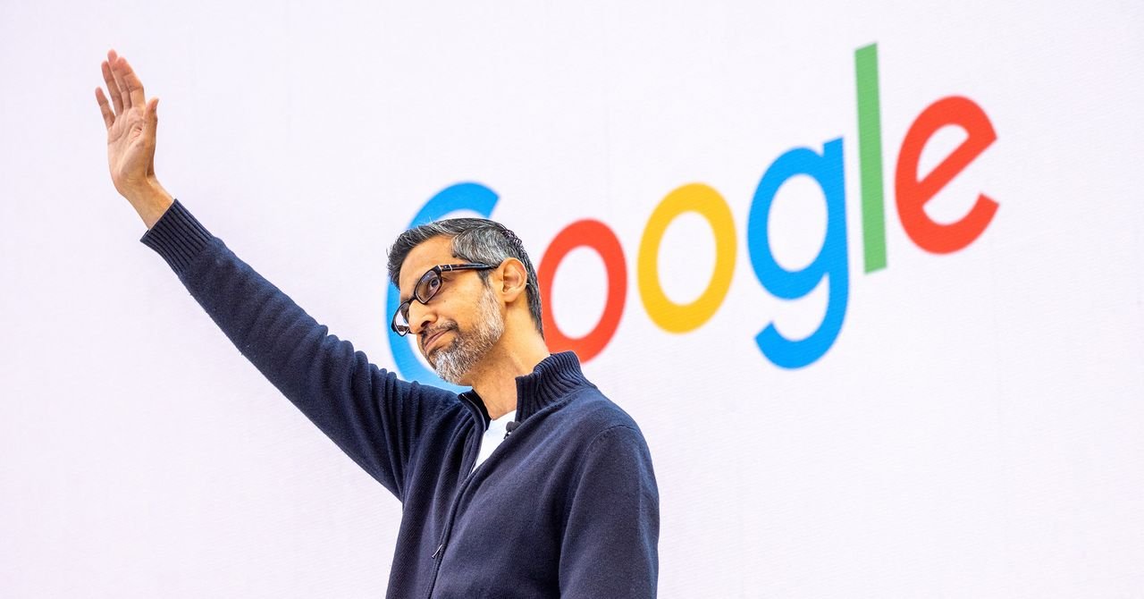 Alphabet CEO Sundar Pichai on stage at Google I/O 2026 keynote, surrounded by futuristic tech visuals.