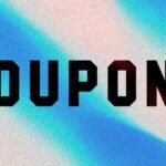 A hand holding a smartphone displaying the Groupon app with various discount offers and promo codes.