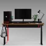 Herman Miller Coyl standing desk with a red coiled power cable, showing its cable management trough and rotary dial.