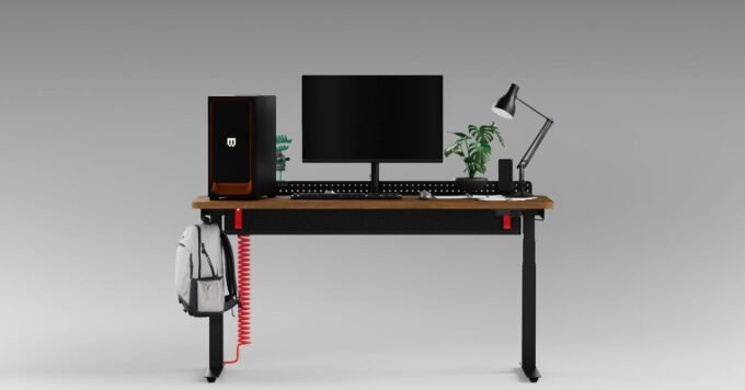 Herman Miller Coyl: The Premium Standing Desk Designed for Discerning Gamers 7 Herman Miller Coyl standing desk with a red coiled power cable, showing its cable management trough and rotary dial.