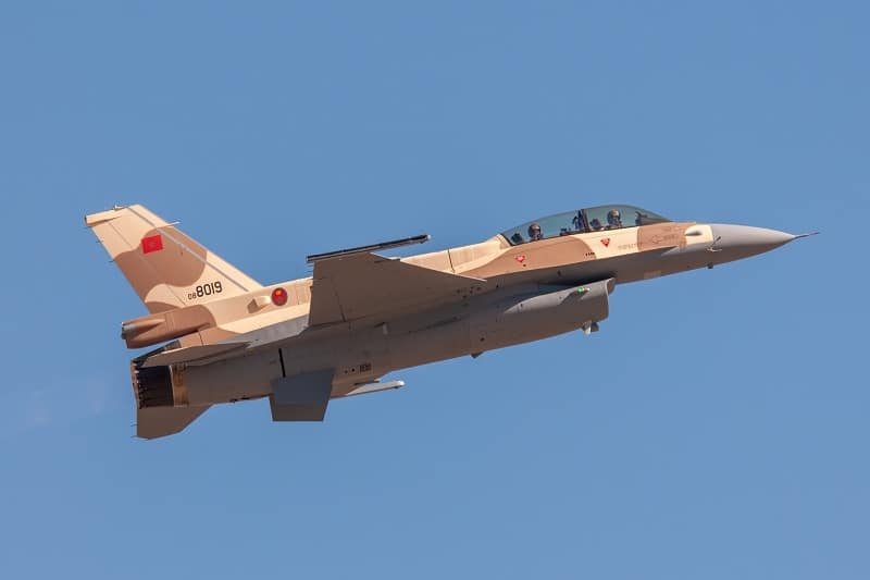 Le Maroc : Quand la Défense Devient le Moteur d'une Ambition Industrielle 3 Un F-16 Block 72 et un hélicoptère AH-64E Apache sur une piste d'atterrissage, symbolisant la modernisation de l'armée marocaine et l'essor de son industrie de défense.